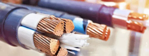 Wire stranding and braiding machinery in operation on the factory floor.